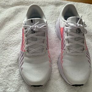 Nike running shoes with pink and burgundy accents.